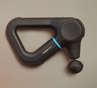 Theragun Prime (6th Gen) massage gun with its triangle handle