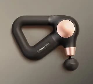Theragun Sense (2nd Gen) massage gun with a rose-gold head