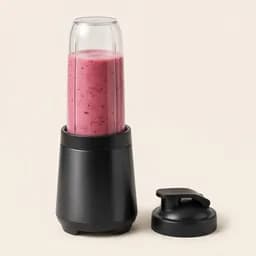 A personal blender with a berry smoothie