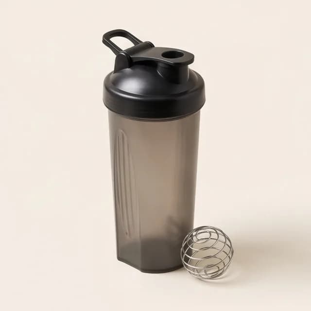 A protein shaker bottle with a whisk ball